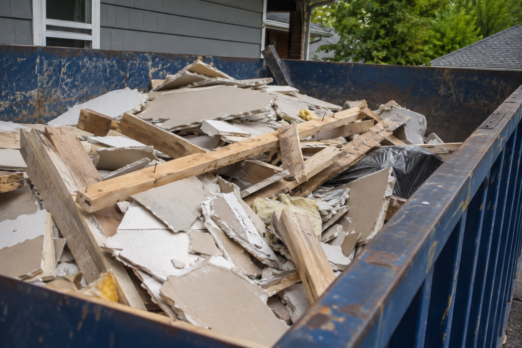 Construction debris loaded into a roll-off dumpster during a home renovation in Puyallup